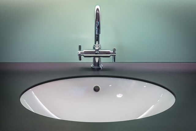 A white bathroom sink basin with a modern chrome faucet