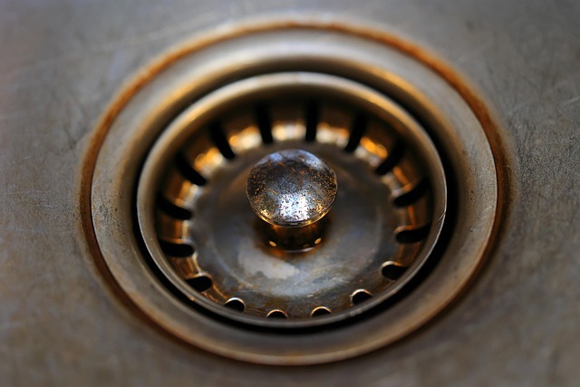 Close up of a stainless steel kitchen sink drain strainer
