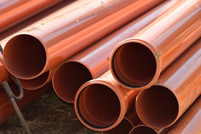 A stack of orange plastic drainage pipes