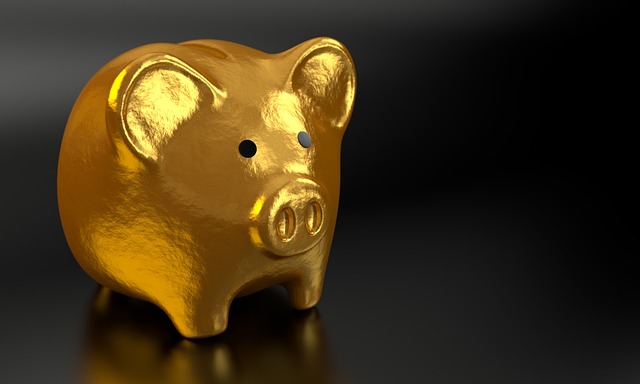 A shiny golden piggy bank against a dark background
