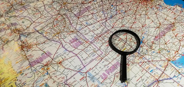 A magnifying glass placed over a detailed road map